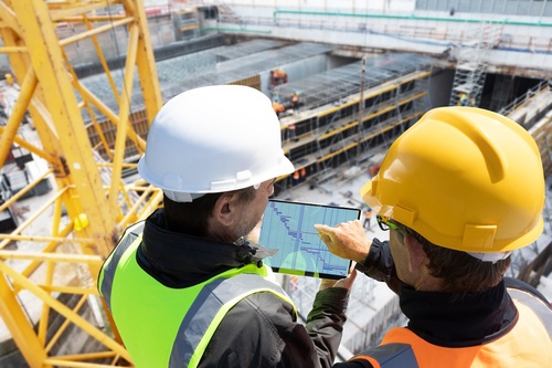 Two,People,Architect,Engineer,Worker,On,Major,Constructionsite,Checking,Progress
